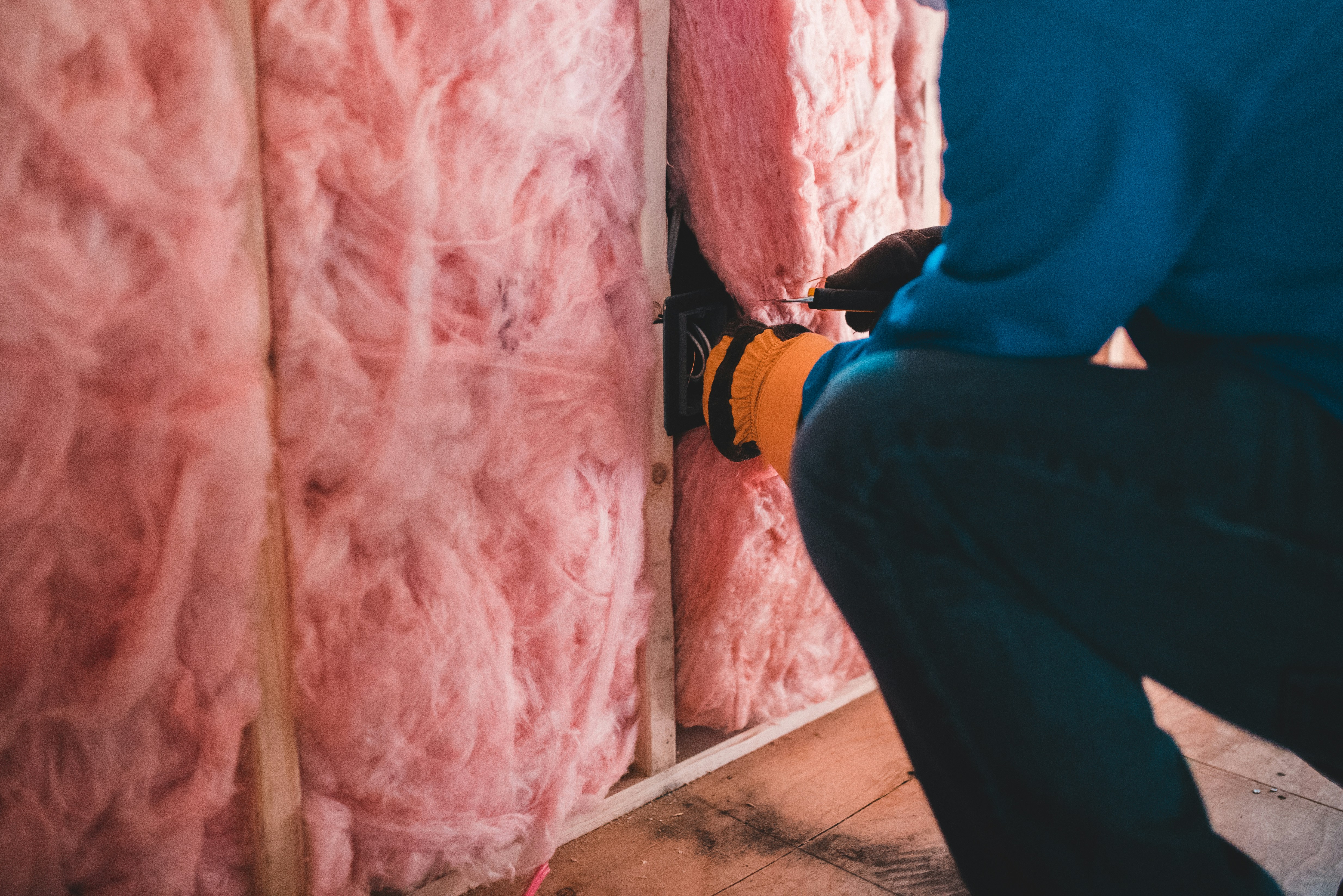 Spray foam insulation being applied to the underside of a roof. Spray foam expands to fill every crack, creating an air-tight barrier against outside heat and humidity.